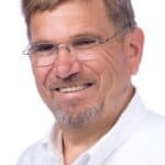 David Devonis, a white man with short brown hair, a goatee, and glasses.